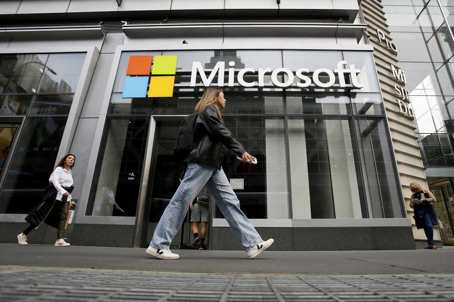 People make their way past a Microsoft on October 26, 2022 in New York City.
