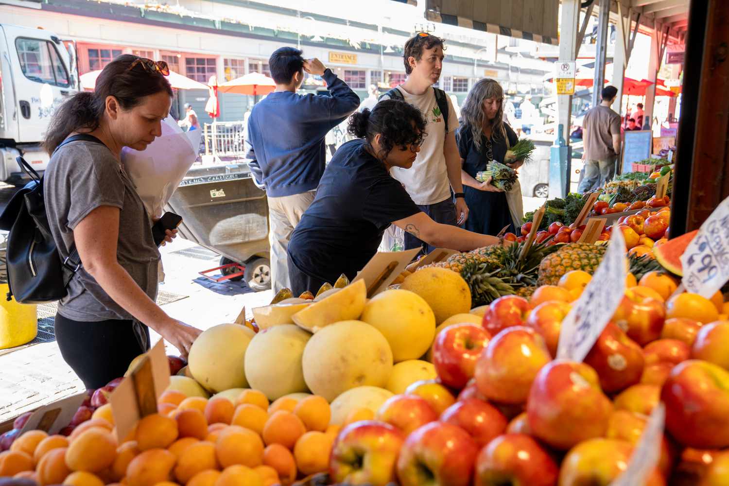 Shoppers look at fruit for sale at Frank's Quality Produce Co. at Pike Place Market in Seattle, Washington