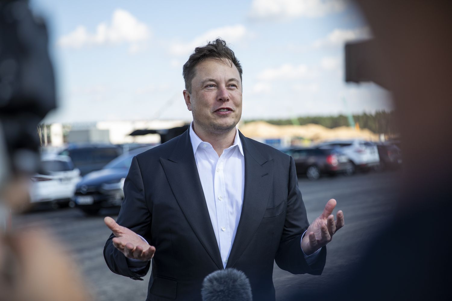 Tesla head Elon Musk talks to the press as he arrives to to have a look at the construction site of the new Tesla Gigafactory near Berlin.