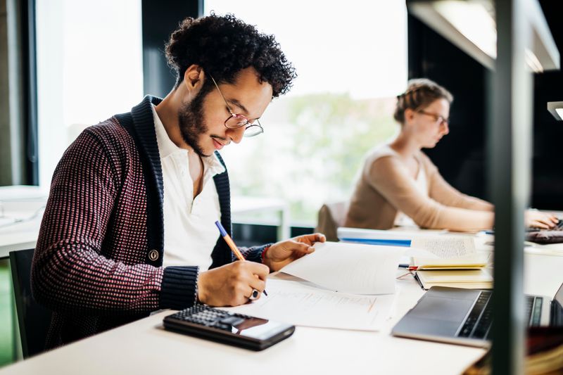 A man calculates which debts to prioritize for a debt avalanche