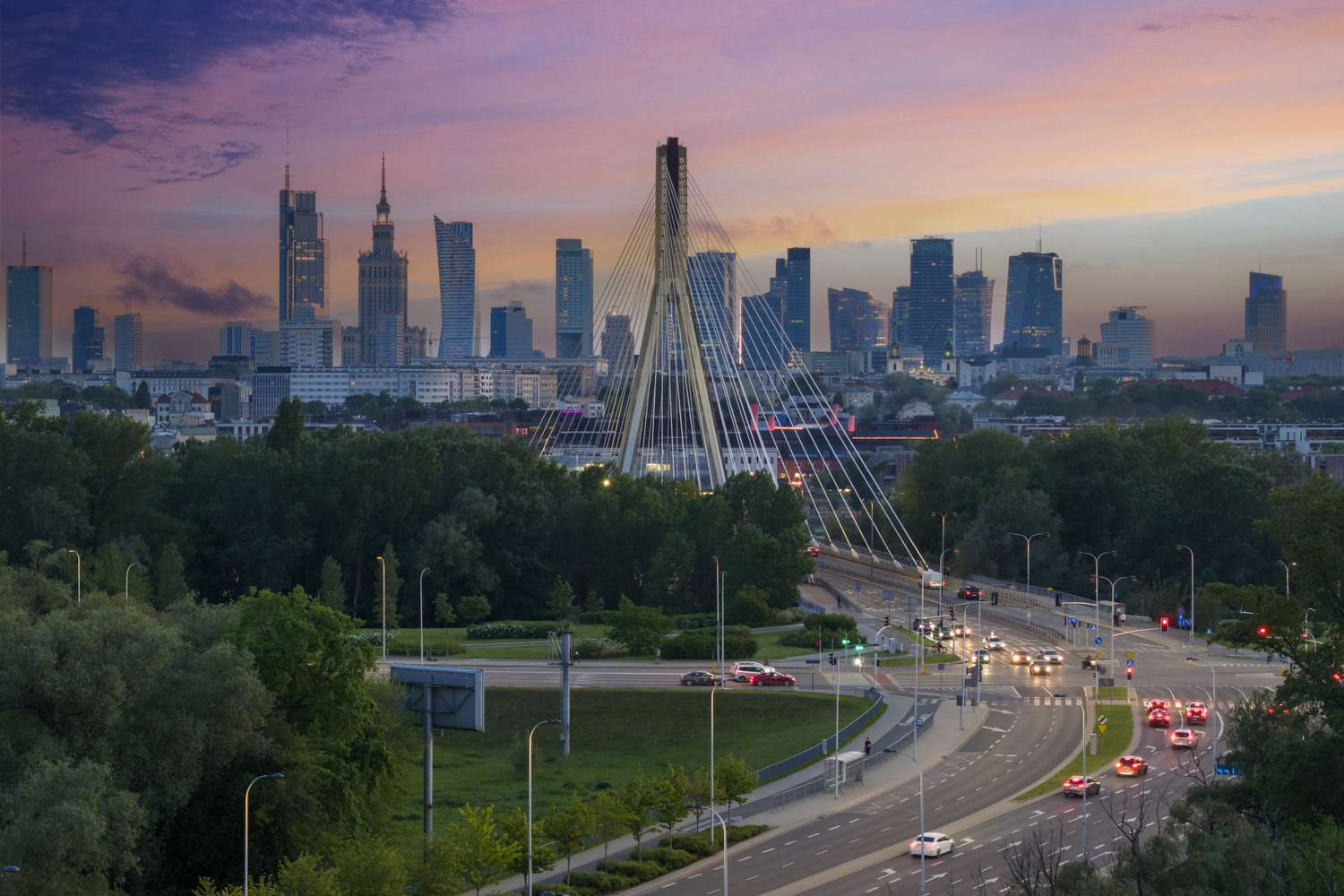Aerial, elevation view of Warsaw city a capital of Poland over Swietokrzyski Bridge during sunset.