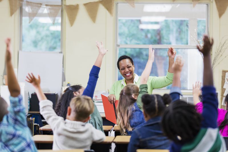 A teacher reads to elementary school classroom children