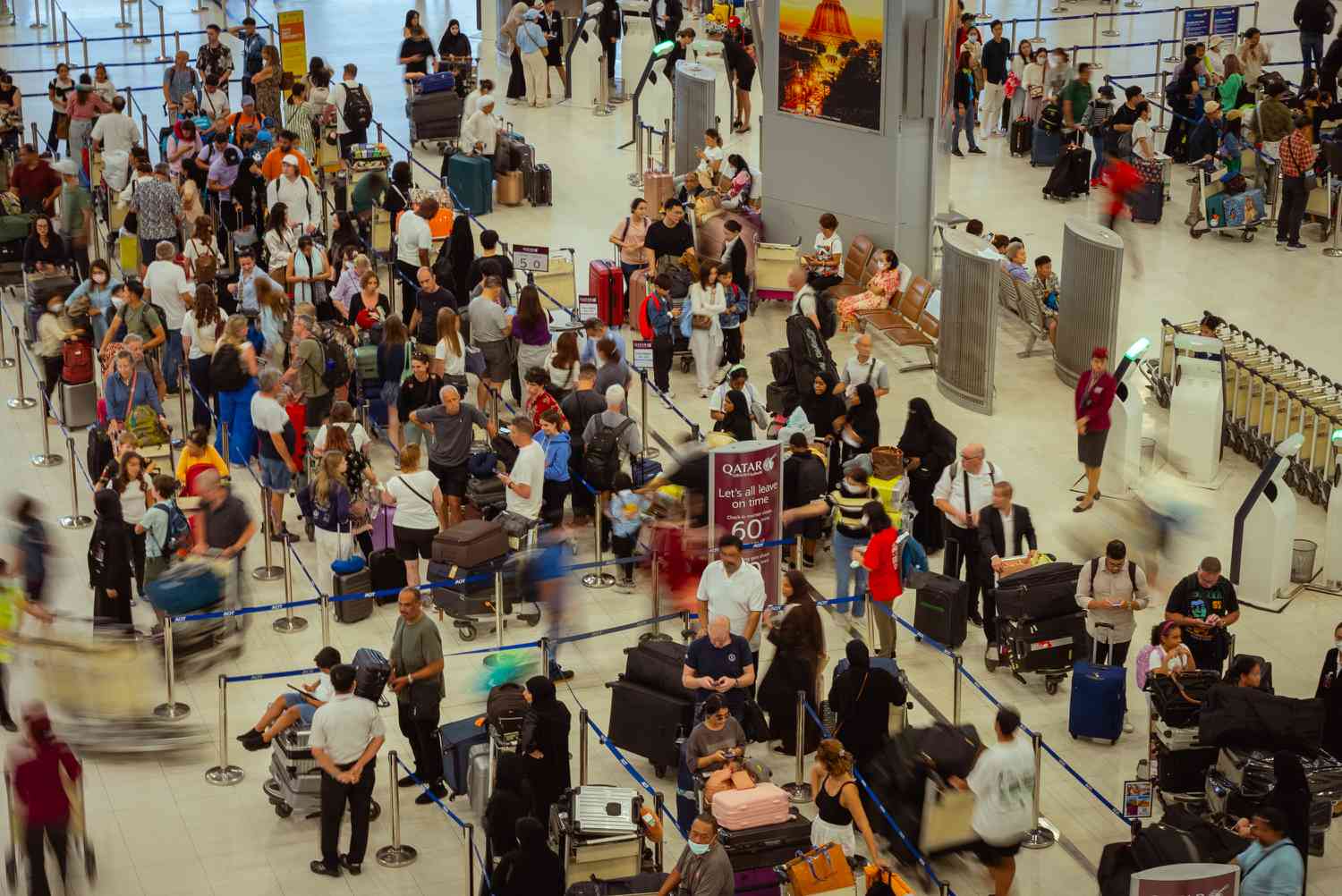 Queues of passengers wait in line at Suvarnabhumi Airport watching the docked airplanes as a global IT disruption caused by a Microsoft outage and a Crowdstrike IT problem combine to affect users on July 19, 2024 in Bangkok, Thailand.