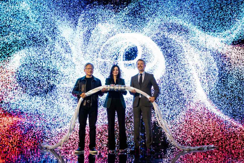 King Frederik X of Denmark (R), CEO and founder of Nvidia Jensen Huang (L), and CEO of the Danish Centre for AI Innovation A/S, Nadia Carlsten (C), symbolically switch on the new AI supercomputer named Gefion at the Vilhelm Lauritzen Terminal in Kastrup, Denmark, on October 23, 2024. 