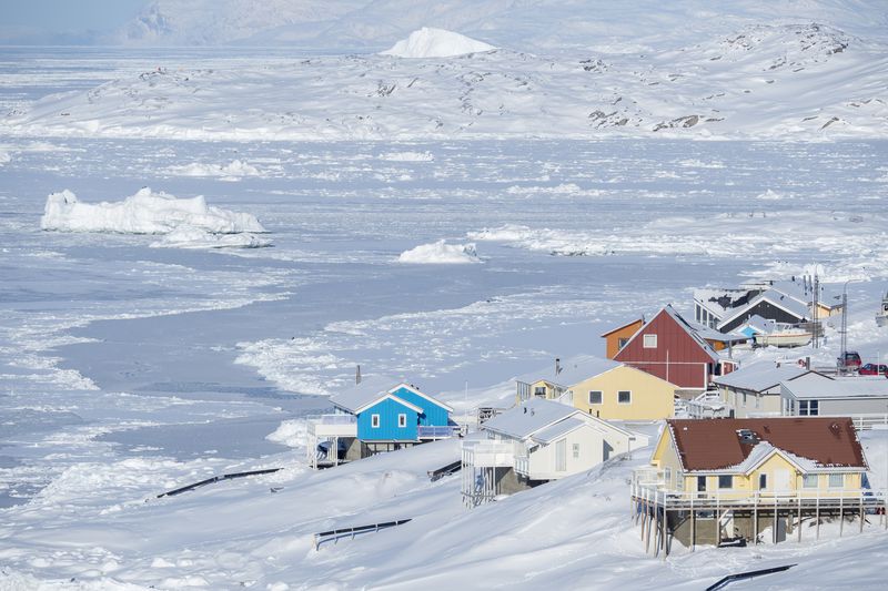 Disko Bay in Greenland showing some houses above the frozen waters