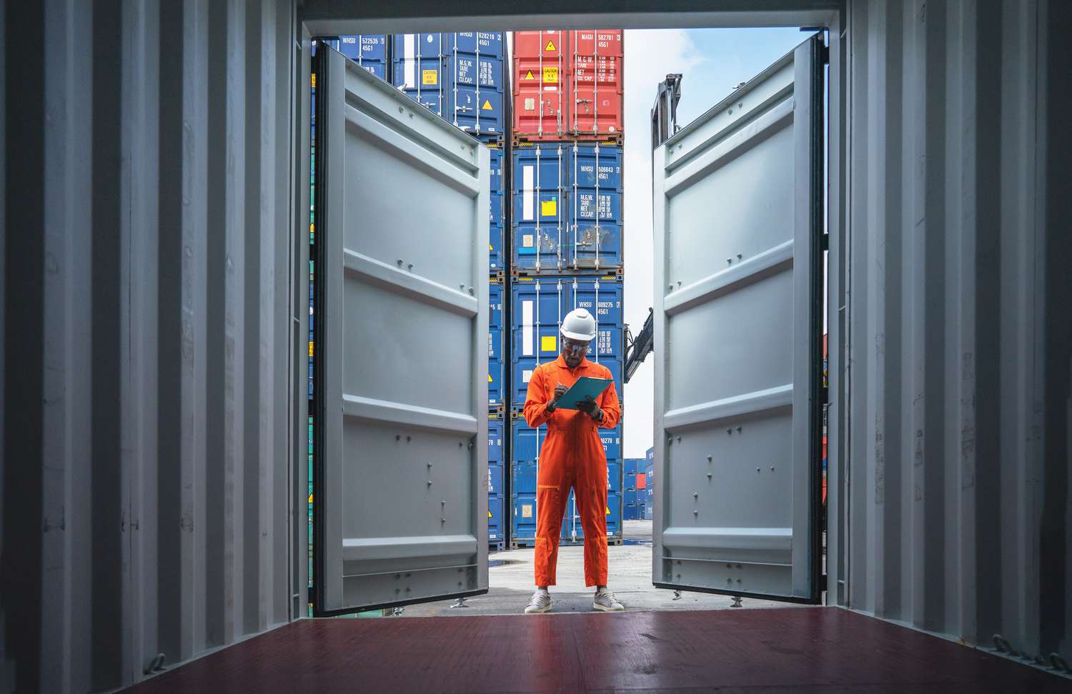Man standing at the entrance to an open shipping container
