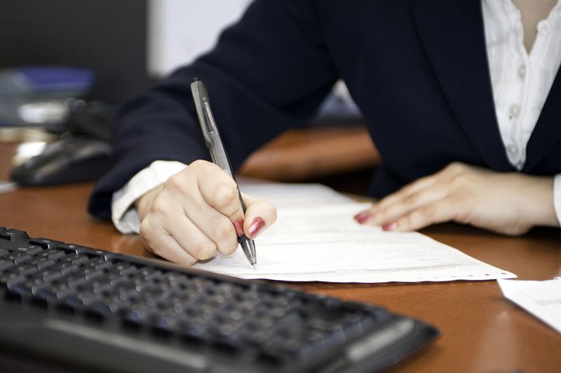 Businesswoman Filling out Contract