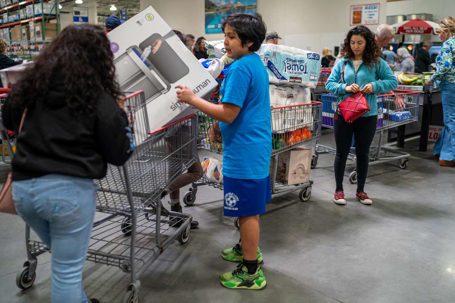 Customers line up at the check out booth on April 18, 2025 at a Costco branch in Niantic, Connecticut