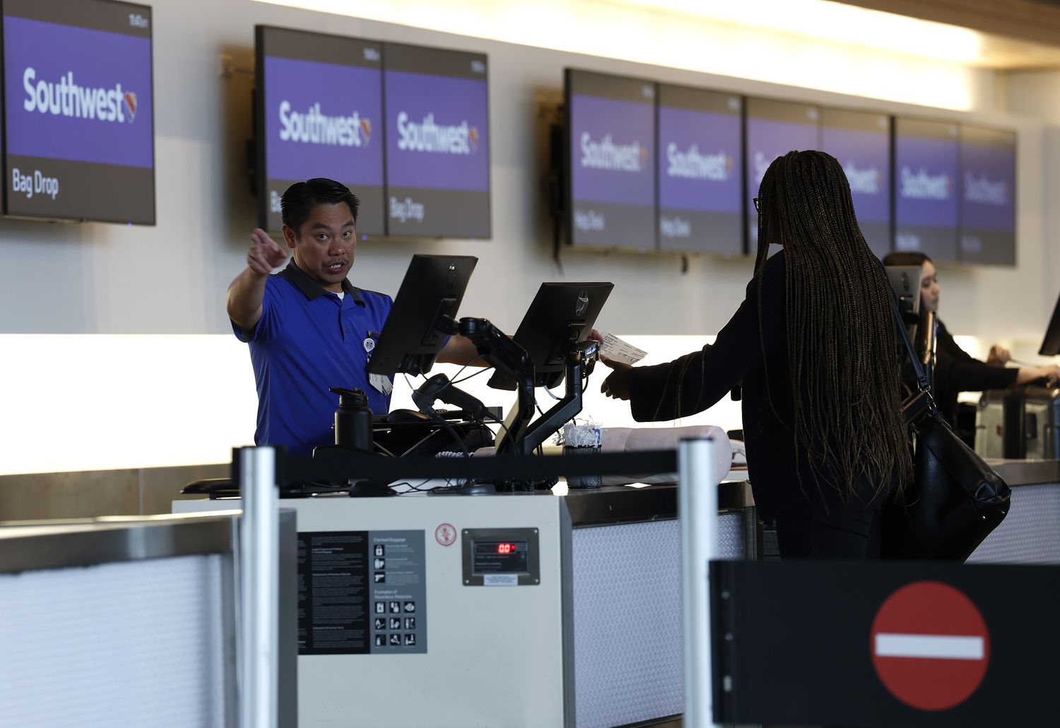 A Southwest Airlines ticketing agent helps customers at San Francisco International Airport on April 24, 2025 in San Bruno, California.