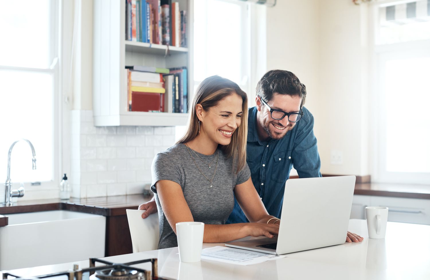 Shot of a young couple using a laptop together at home