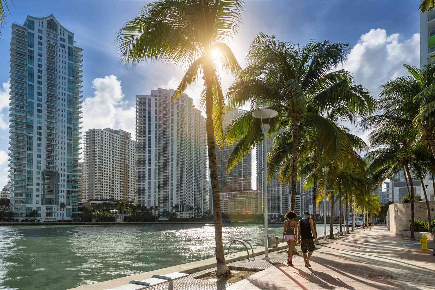 A couple walking along the Miami River in downtown Miami.