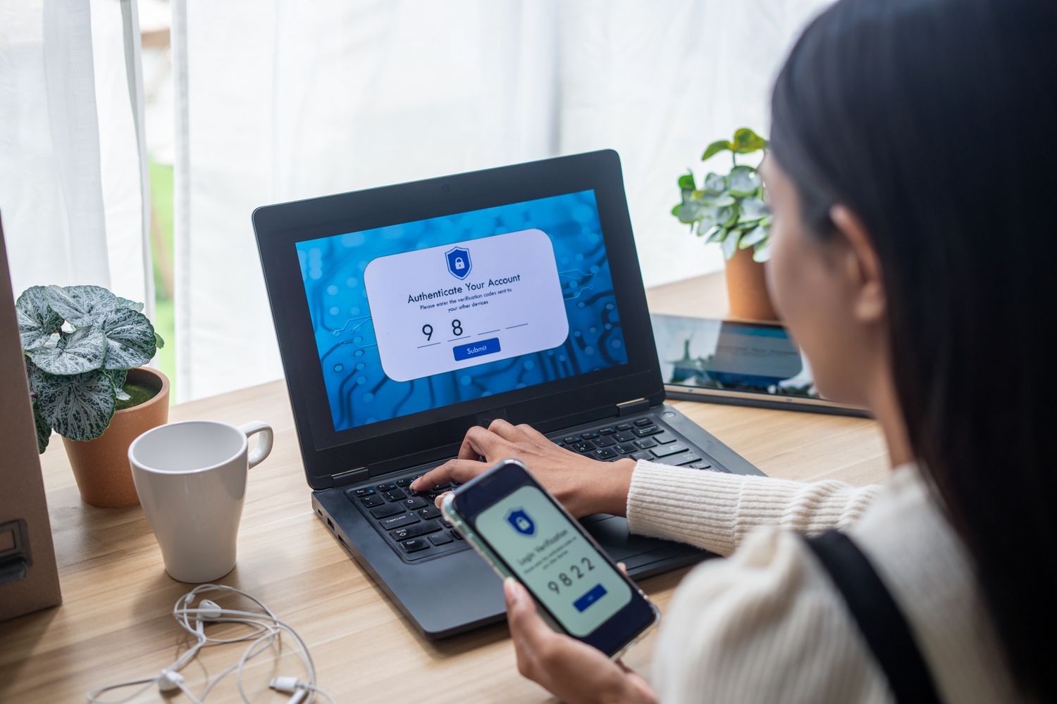 A person using two factor authentication on laptop to prevent online identity thief.
