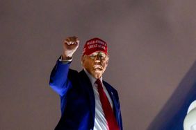 US President Donald Trump pumps his fist as he boards Air Force One before departing Miami International Airport, in Miami, Florida on April 3, 2025.