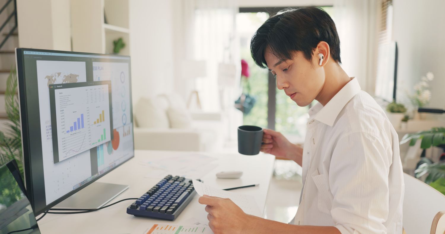 Asian man sitting at his desk in a home office 