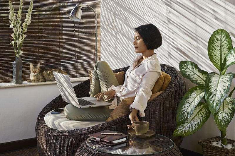 A woman uses a laptop in a home.
