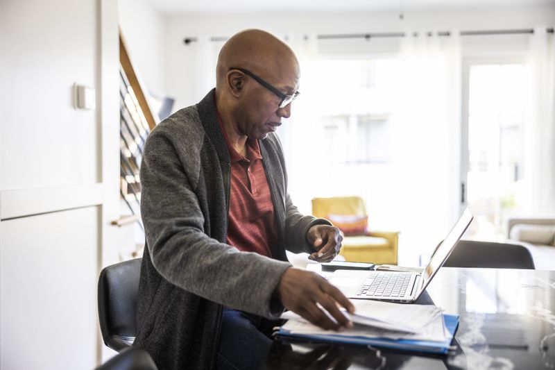 Man planning his retirement trying to figure out how much taxes are on an IRA withdrawal. 