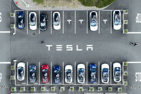 An aerial view of Teslas parked in a lot. 