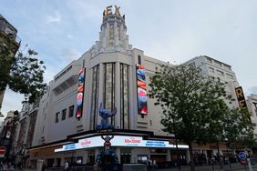 An imitation of Stitch from 'Lilo & Stitch' sits atop a theater awning in Paris. 