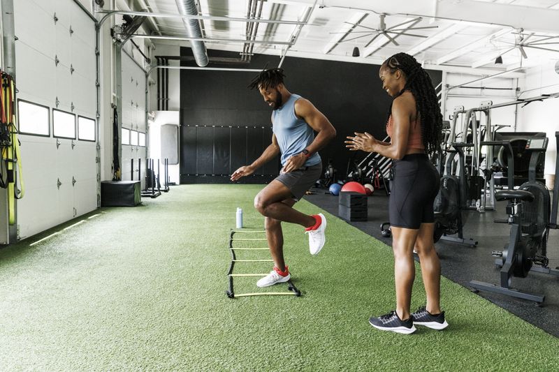 Personal trainer at gym with client 