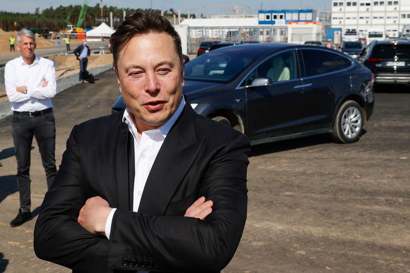 Tesla CEO Elon Musk talks to media as he arrives to visit the construction site of the future US electric car giant Tesla, on September 03, 2020 in Gruenheide near Berlin