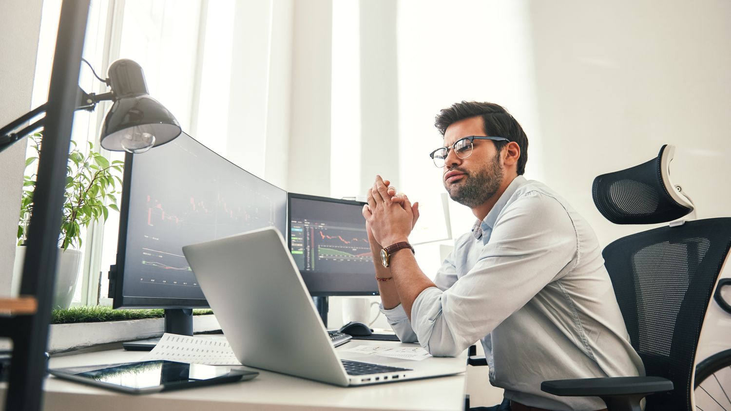 A day trader uses computer monitors to look at the New York Stock ExchangeTick Index to gauge the market.
