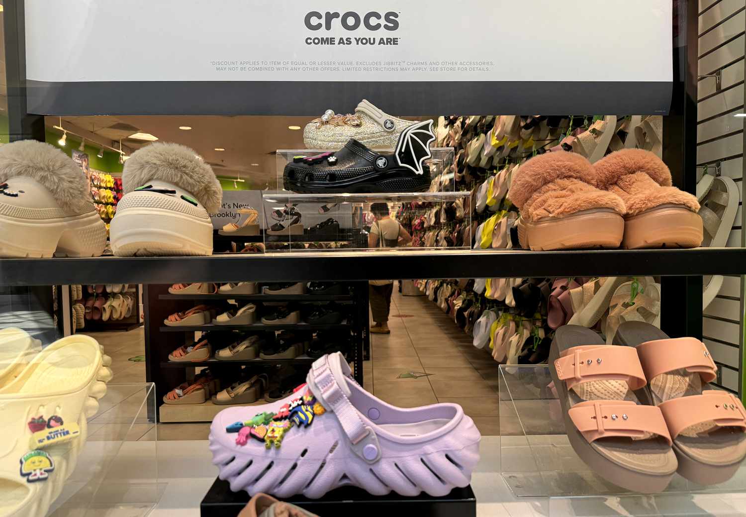 A Crocs show display in a store window