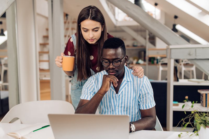 Couple reading on their computer whether they can deduct an IRA on their tax returns