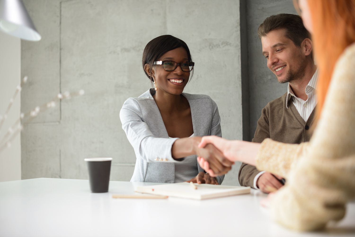 Couple sitting in a meeting with their financial advisor.