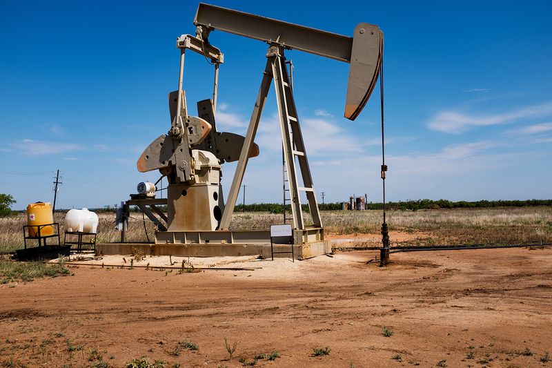 Crude oil extraction pump pulling crude oil up to the surface and pushing it into pipelines in the Permian Basin in West Texas.