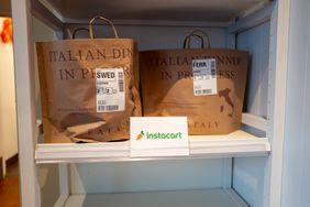 Instacart orders sit on a shelf. 
