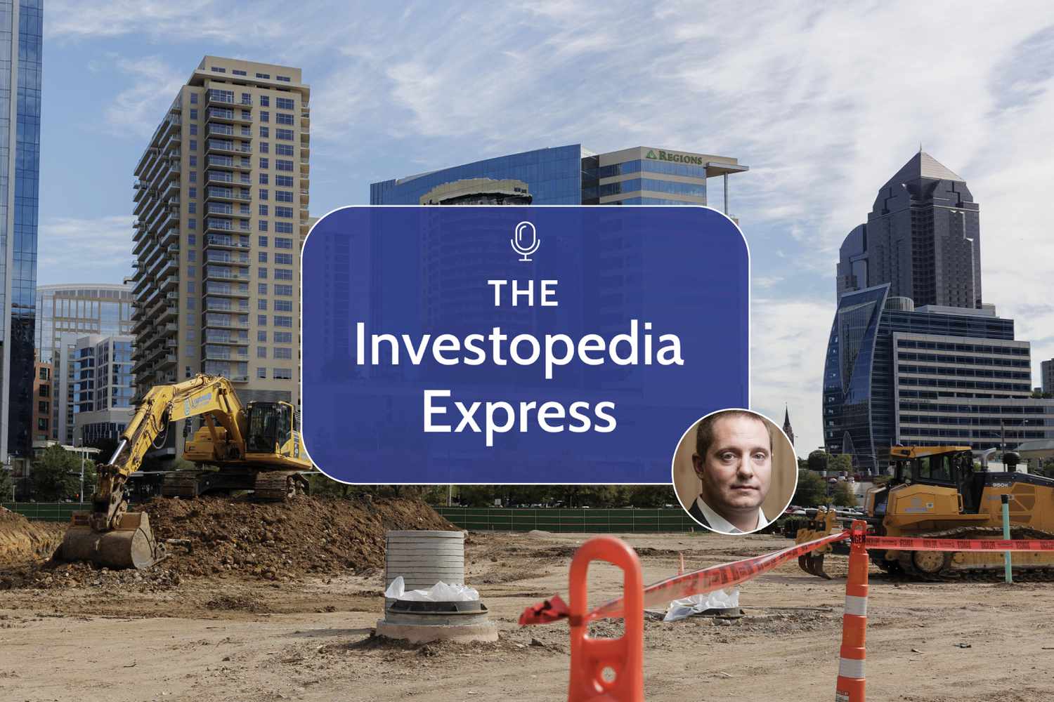 Image of bulldozers at a construction site in front of tall buildings 