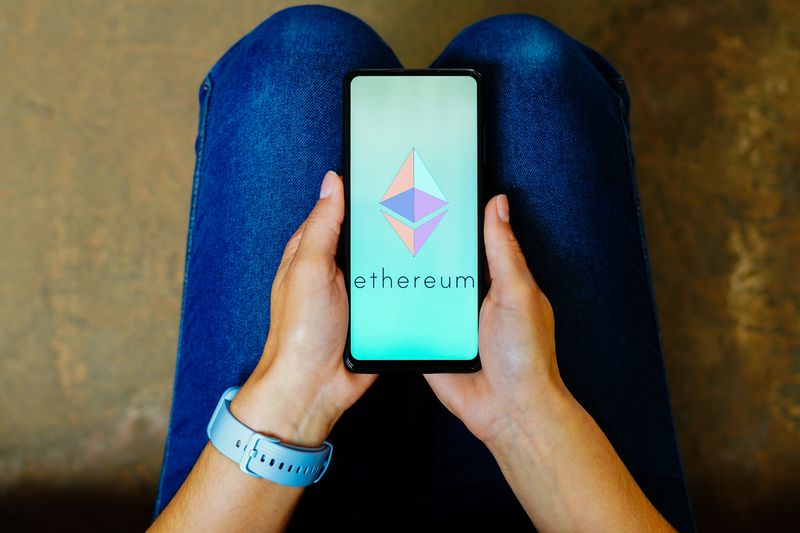 Ethereum symbol on phone with person holding it