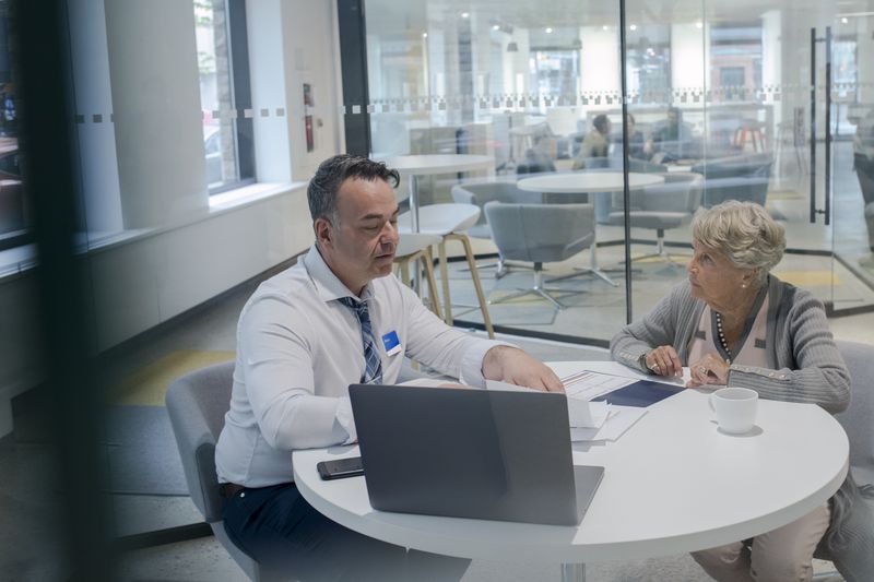 Loan officer explains the risk of unsecured loan to customer.