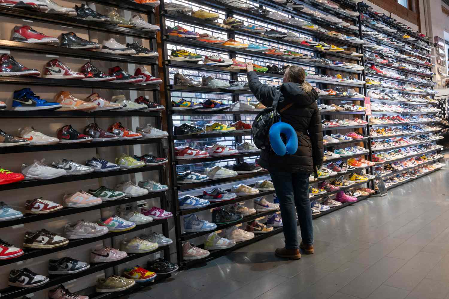 A shopper looks at shoes in a store. 