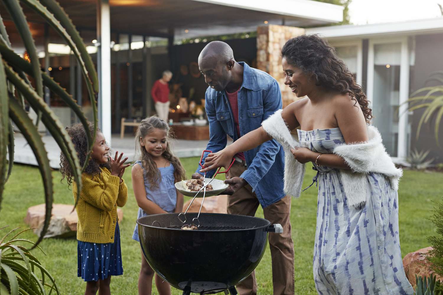 family in backyard of high value home