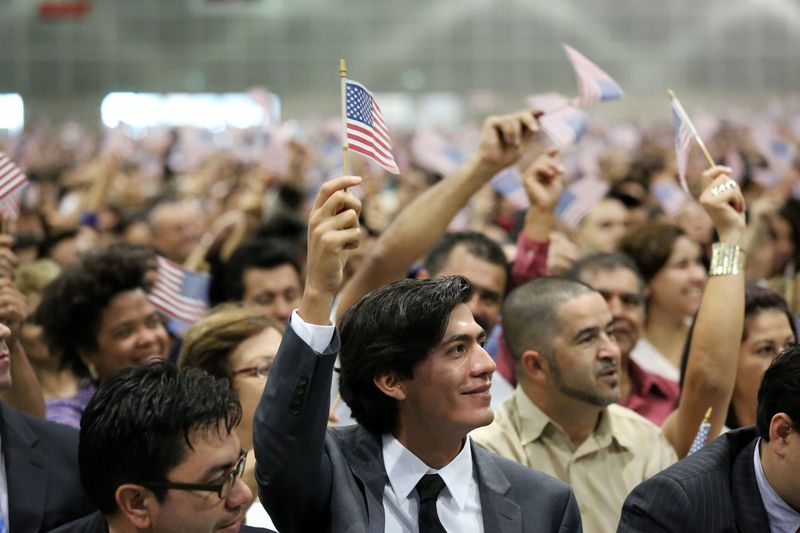 Immigrants being sworn in as U.S. citizens represent the process of acculturation.
