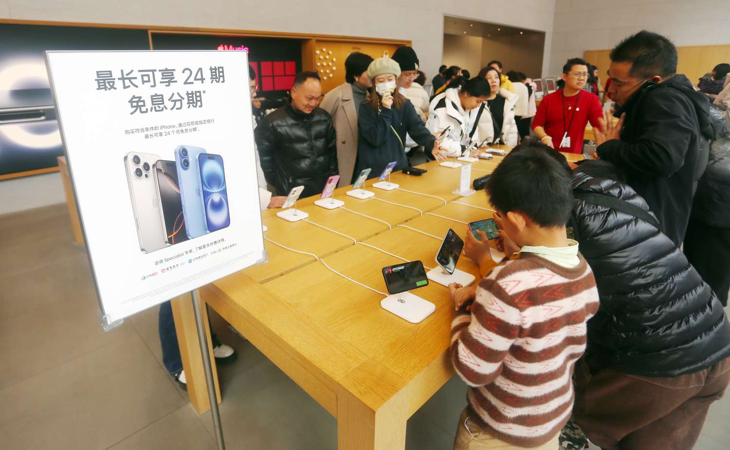Customers shop at the Apple flagship store on Nanjing Road Pedestrian Street in Shanghai, China, January 23, 2025. 