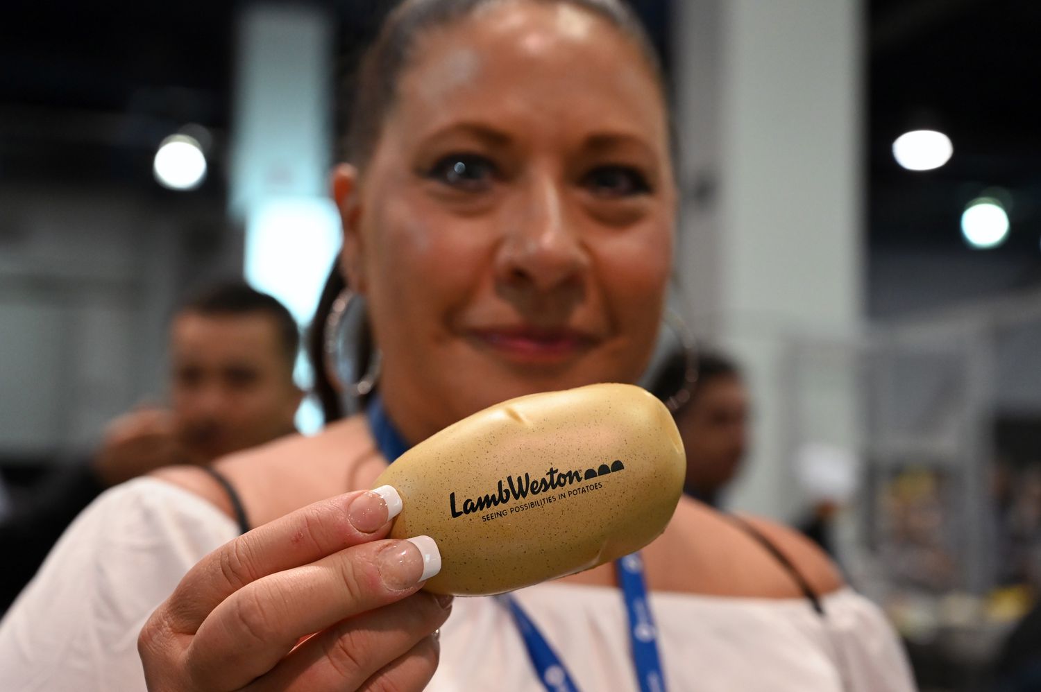 A woman holds a Lamb Weston branded action at an expo in Las Vegas in 2021. 