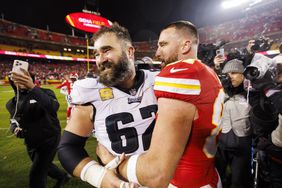 Jason Kelce, left, embraces his brother Travis after an NFL game in November 2023.