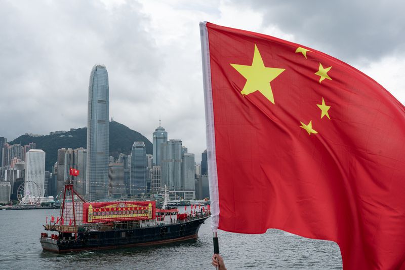 Fishing boats fly Chinese and Hong Kong flags during a parade at the Victoria Harbour on July 01, 2023 in Hong Kong, China.