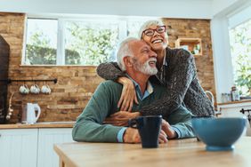 Elderly couple hugging in the kitchen