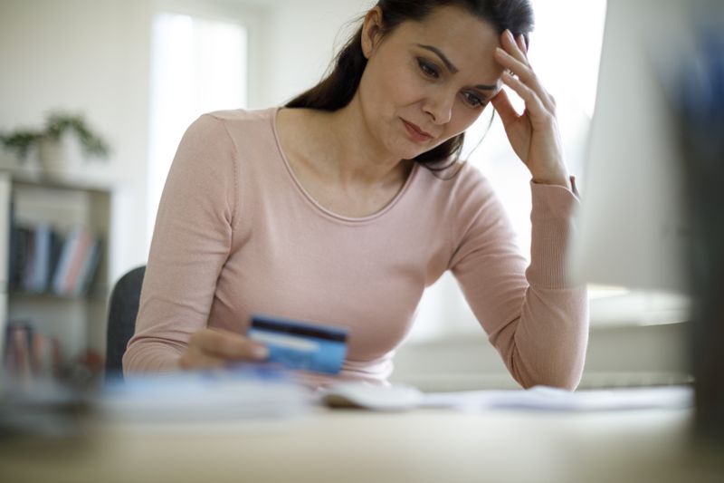 Woman reading about the basics of her credit card