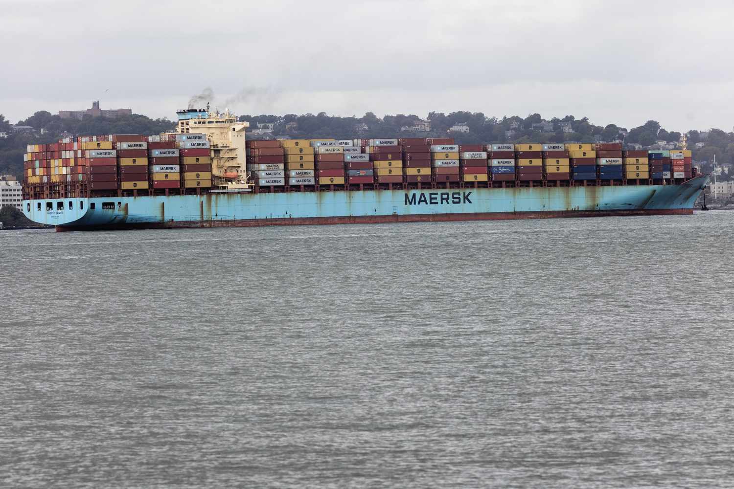 A cargo ship enters New York harbor, October 3, 2024, seen from Brooklyn, New York City.