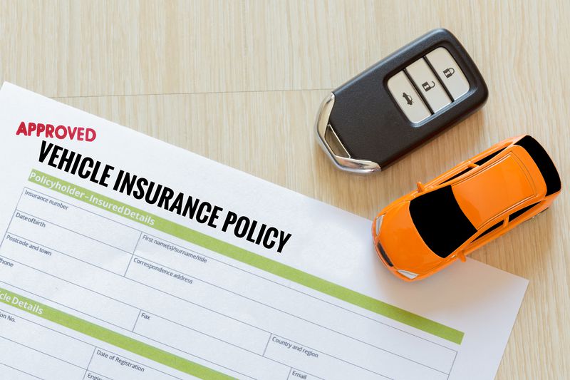 Car Insurance Claim Form With Toy And Key On Table