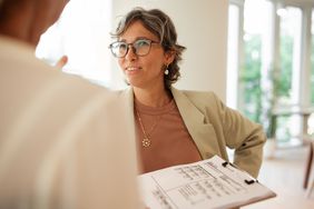 Gen X woman talking to a colleague. 