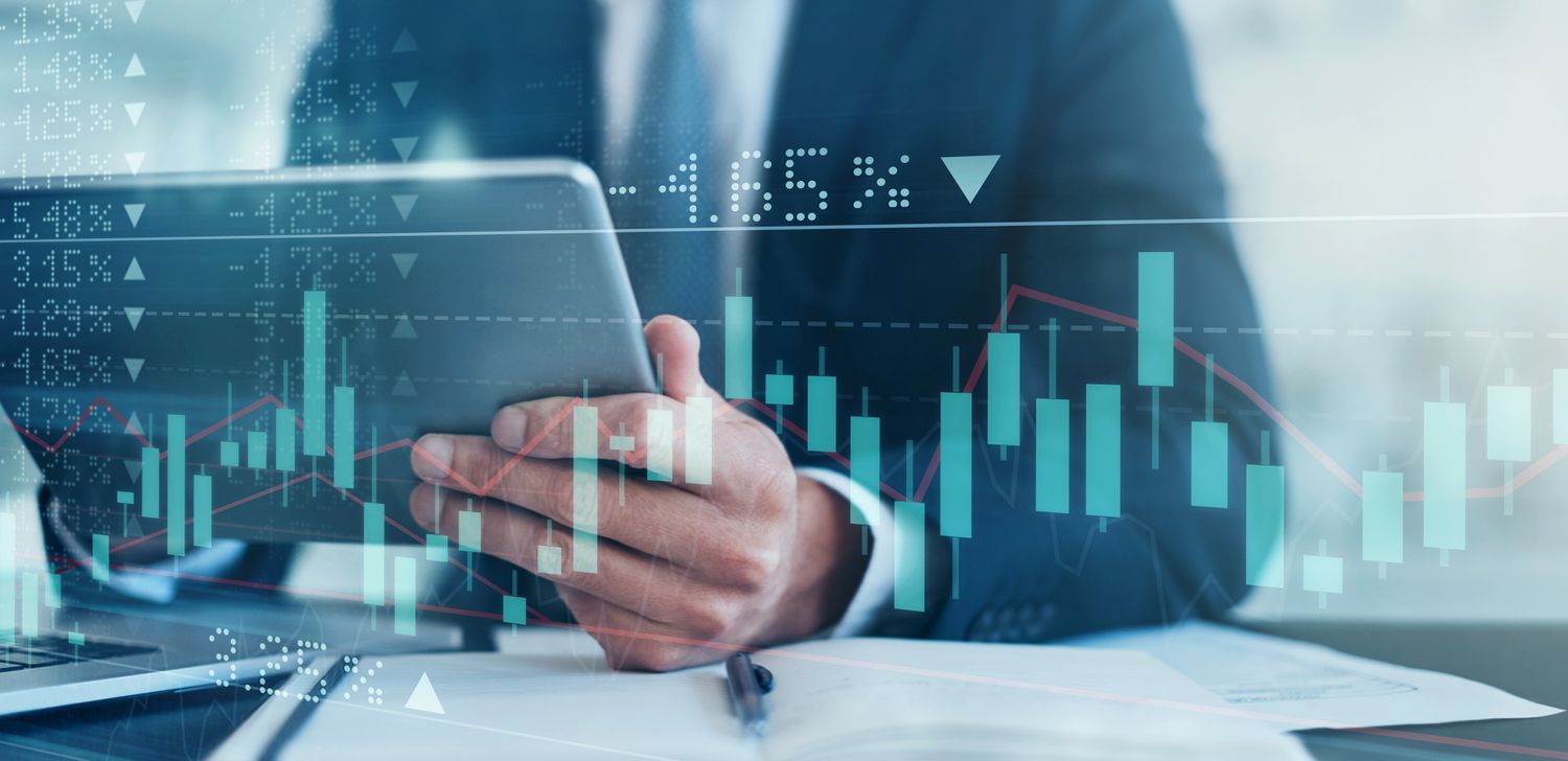 Person sitting at a tablet with a stylus looking at penny stock data