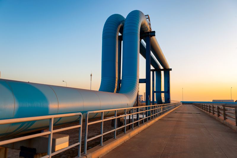 Blue pipelines leading to a refinery