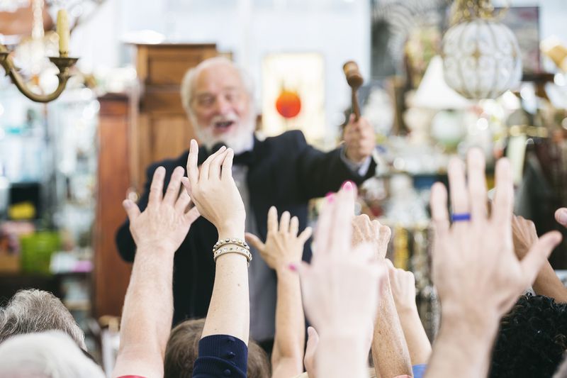 Auctioneer with large crowd of buyers