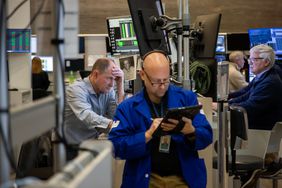 Traders work on the floor in the American Stock Exchange area of the New York Stock Exchange