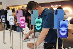 Customers experience the iPhone 16 series at Apple's flagship store in Shanghai, China, October 15, 2024